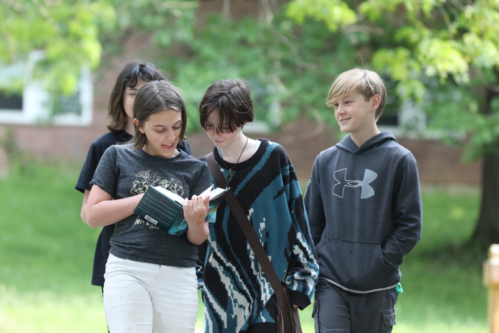 A group of Oakwood Friends School MS students walking on a sunny day