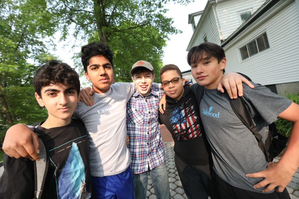 A group of Oakwood Friends School upper school students of a variety of ethnicities posing for the camera