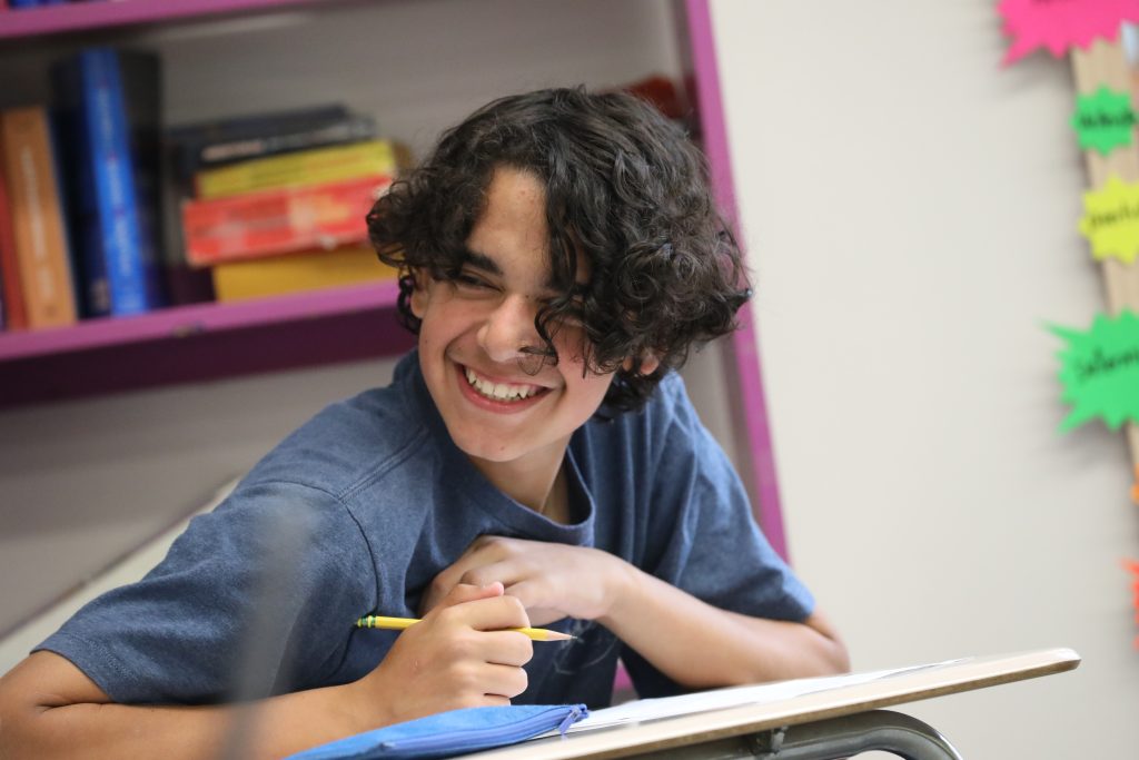 A young male student enjoys a lesson