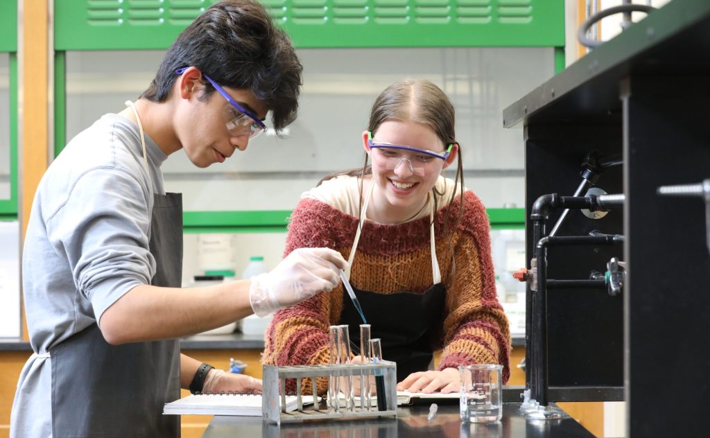 two high school students working on a chemistry project in Oakwood Friends School