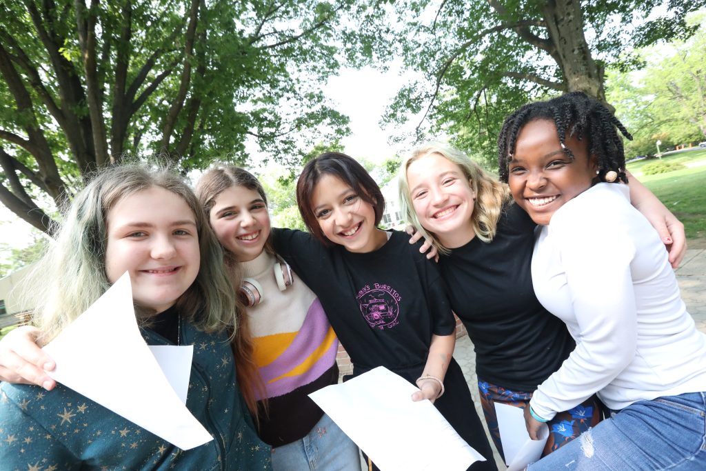 A group of Oakwood Friends School middle school students of a variety of ethnicities posing for the camera